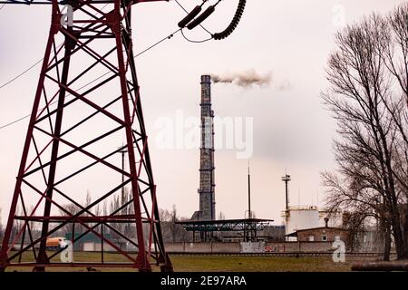 high-voltage power lines and smoky pipes of the metallurgical plant. Stock Photo