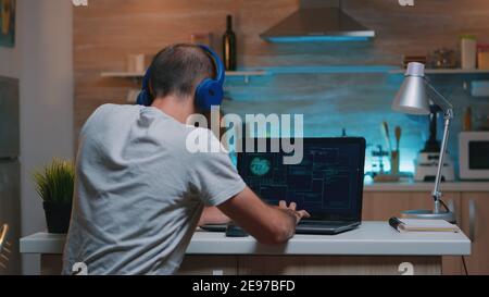 Man hacker with headset coding html and programming on screen laptop ...