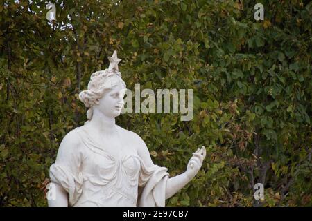 statue of a person in a garden Stock Photo