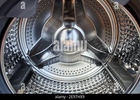Empty drum of front loading washing machine. Stock Photo