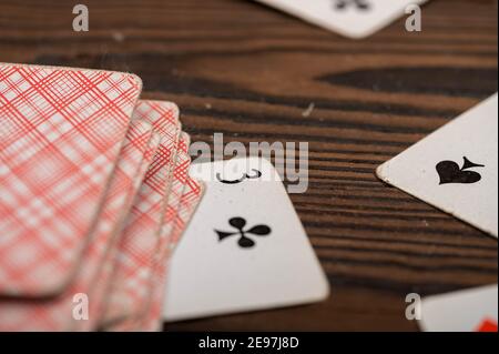 Playing cards on a wooden table. Close-up, selective focus. Stock Photo