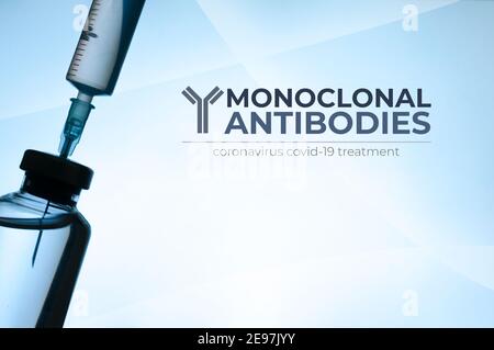Monoclonal antibodies concept image: vial and syringe silhouette on light blue background Stock Photo