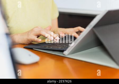 Businesswoman typing on laptop keyboard working from home conceptual. Stock Photo