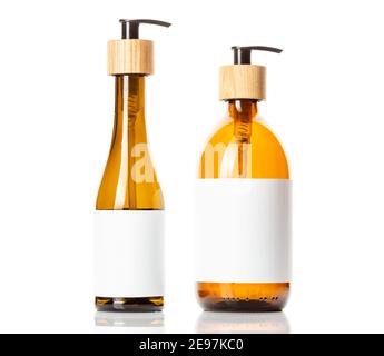 Brown glass pump dispenser bottle for cosmetics, white label with space for text, isolated on white. Bathroom accessory, Beauty product packaging Stock Photo