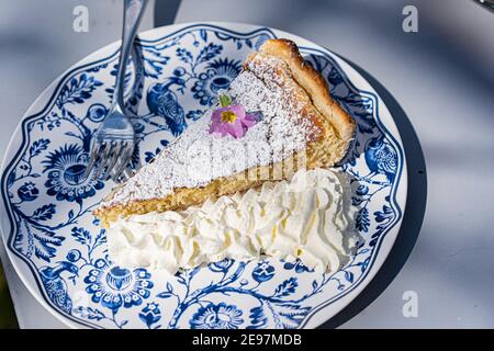 Fresh self made easter pie with flower and cream decoration outdoor. Stock Photo