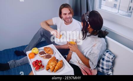 Young newlywed couple having breakfast in bed. High quality photo Stock Photo