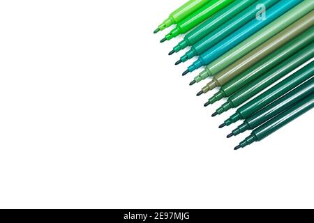 Set of green colored felt-tip pens for drawing on isolated background. Different shades of green. Top view, copy space Stock Photo