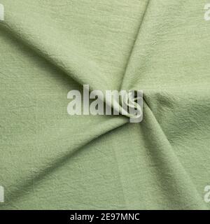 Crumpled natural green fabric texture background Stock Photo