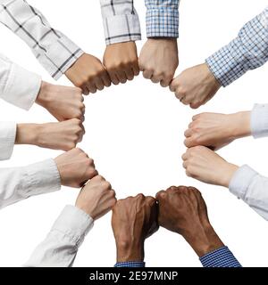 Group of people putting their fists together in shape of circle. Stock Photo