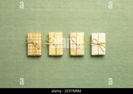 Yellow gift boxes on green fabric background. flat lay, top view, copy space Stock Photo