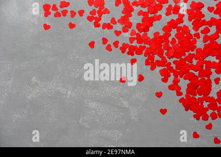 A lot of small red hearts on gray concrete background Stock Photo