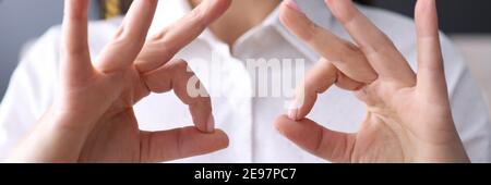 Businesswoman holds her finger in gesture of ok. Stock Photo