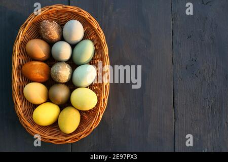Naturally dyed Easter eggs in the basket background. Stock Photo