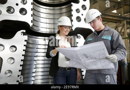 Topic photo, job cuts at Siemens Energy - young engineers at a meeting, cooperative engineersTraining at Siemens Energy, cooperative engineering train Stock Photo