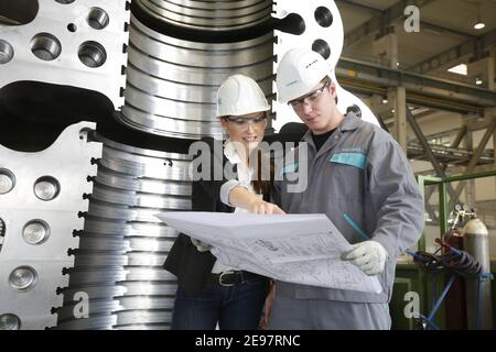 Topic photo, job cuts at Siemens Energy - young engineers at a meeting, cooperative engineersTraining at Siemens Energy, cooperative engineering train Stock Photo