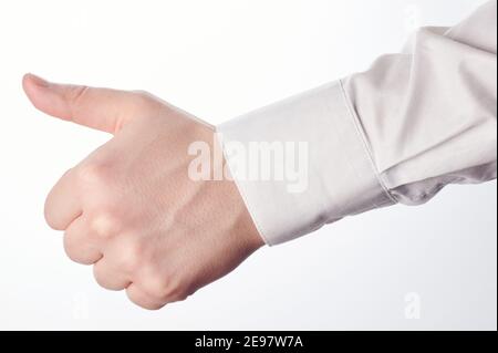 Approved finger sign guest theme. Thumb up hand isolated on white studio background Stock Photo