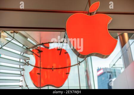 Hong Kong, China - December 4, 2016: two red Apple logos face to face in Apple store of IFC Mall, with crystal central stairway of this three levels Stock Photo