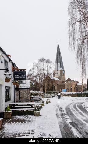 Almondsbury in the Snow.  St Mary's parish church and the Bowl Inn Stock Photo