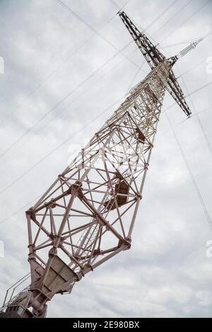 Glass insulators on high-voltage power line poles. Stock Photo