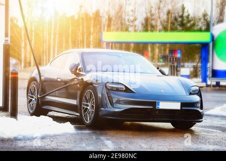 Porsche Taycan 4S electric car charging at Ionity. Paimio, Finland Jan 23, 21. Debuted in 2020, Porsche Taycan is the first all-electric car by Porsch Stock Photo