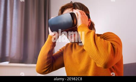 Young caucasian man using VR goggles. High quality photo Stock Photo