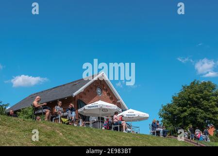 People sitting in the cafe at the flood embankment, Greetsiel, Lower Saxony, Germany, Europe Stock Photo
