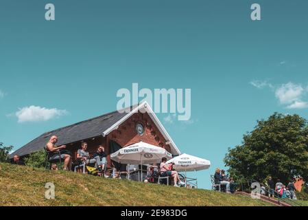 People sitting in the cafe at the flood embankment, Greetsiel, Lower Saxony, Germany, Europe Stock Photo