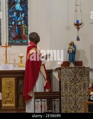 Brentwood Essex 3rd February 2021 Live streaming of a mass (holy communion) from St Thomas of Canterbury parish church Brentwood Essex, The Celebrant is Fr Oswald Trellis (Pictured) (Pictures taken with permission of the Clergy). Credit: Ian Davidson/Alamy Live News Stock Photo