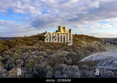 snowy aerial photo about Csesznek castle ruins in Bakony Mountain Hungary. Built was by Jakab Cseszneki in 1263. Amazing historical building ruins. Stock Photo