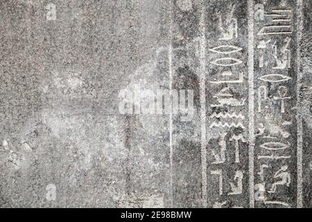 Alexandria, Egypt. Gray stone wall with Egyptian hieroglyphs. Pompeys Pillar historical site Stock Photo