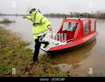 Rees, Germany. 03rd Feb, 2021. A campsite visitor gets out of the fire boat 'Bienchen' in Grietherort. The further rising flood waters have cut off the community of Rees-Grietherort on the Lower Rhine from the access roads and turned it into an island. Credit: Roland Weihrauch/dpa/Alamy Live News Stock Photo