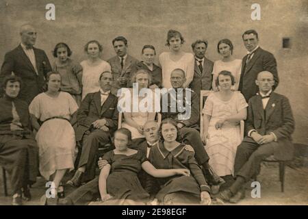 Latvia - CIRCA 1920s: Group photo of party guests. Vintage historical archive photo. Some men in uniform. Stock Photo