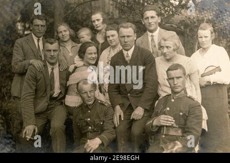 Latvia - CIRCA 1920s: Group photo of party guests. Some men in uniform. Vintage historical archive photo Stock Photo