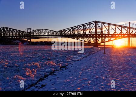 Sunset by the frozen St Lawrence River, Quebec, Canada Stock Photo