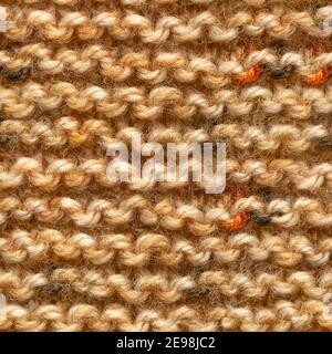Brown yellow knitted fabric seamless pattern for borderless fill. Knitted fabric repeating pattern for background close up. Stock Photo