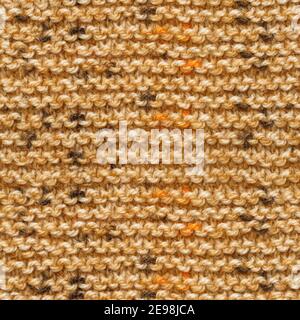 Brown yellow knitted fabric seamless pattern for borderless fill. Knitted fabric repeating pattern for background close up. Stock Photo