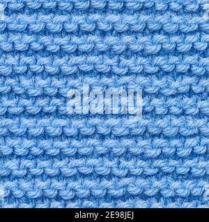 Blue knitted fabric seamless pattern for borderless fill. Knitted fabric repeating pattern for background close up. Stock Photo