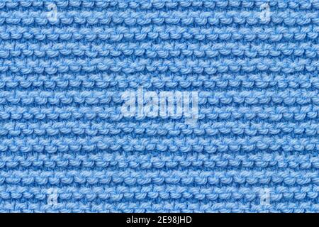 Blue Knitwear Fabric Texture. Machine Knitting Texture Macro Snapshot. Blue Knitted Background. Stock Photo