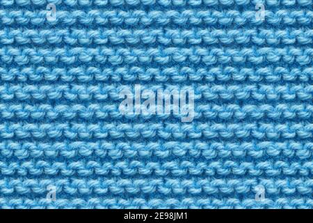 Blue Knitwear Fabric Texture. Machine Knitting Texture Macro Snapshot. Blue Knitted Background. Stock Photo