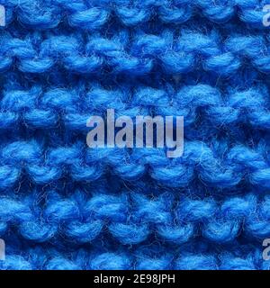 Dark blue knitted fabric seamless pattern for borderless fill. Knitted fabric repeating pattern for background close up. Stock Photo