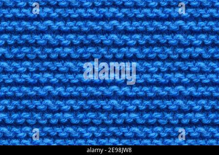 Blue Knitwear Fabric Texture. Machine Knitting Texture Macro Snapshot. Dark Blue Knitted Background. Stock Photo