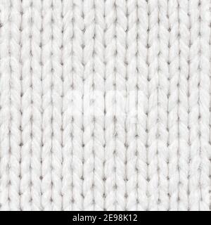White knitted fabric seamless pattern for borderless fill. Knitted fabric repeating pattern for background close up. Stock Photo