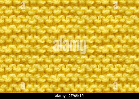Yellow Knitwear Fabric Texture. Machine Knitting Texture Macro Snapshot. Knitted Background. Stock Photo