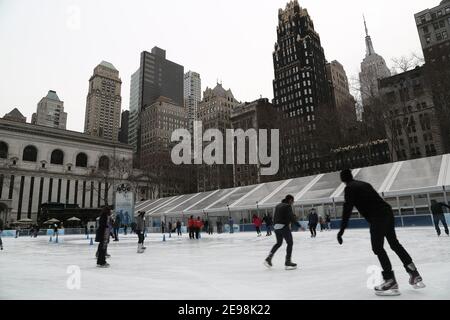 A general view of the ice skating rink in Bryant Park in Manhattan, New York, overlooked by the Empire State Building Stock Photo