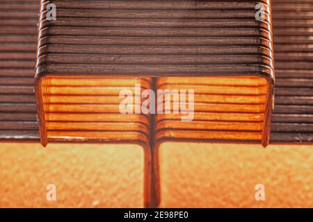 Coppered staples photographed close-up in brown tones. Three groups of copper staples arranged in a pyramid shape Stock Photo
