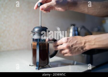 Making French Press coffee in the kitchen Stock Photo