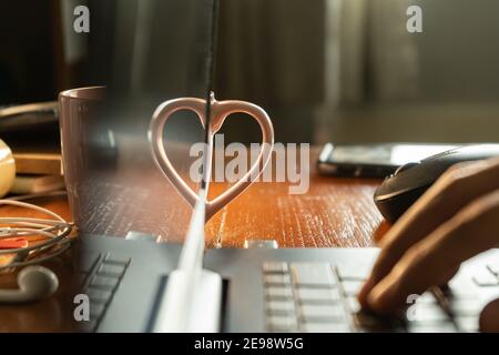 A heart shape made from a mug handle and the reflection from laptop display Stock Photo