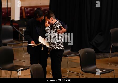 WASHINGTON, DC - FEBRUARY 3: Wen-Ling Chestnut, right, the wife of Capitol Police Officer J.J. Chestnut, who died in the line of duty along with Detective John Gibson on July 24, 1998 is comforted after attending the Congressional ceremony memorializing U.S. Capitol Police Officer Brian D. Sicknick, 42, as he lies in honor in the Rotunda of the Capitol on Wednesday, February 3, 2021. Officer Sicknick was responding to the riot at the U.S. Capitol on Wednesday, January 6, 2021, when he was fatally injured while physically engaging with the mob. Members of Congress paid tribute to the officer o Stock Photo