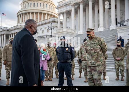 U.S. Secretary of Defense Lloyd J. Austin III, left, meets with U.S. Army Maj. Gen. William J. Walker, commanding general, District of Columbia National Guard, and others assisting with security at the U.S. Capitol building January 29, 2021 in Washington, DC. Stock Photo