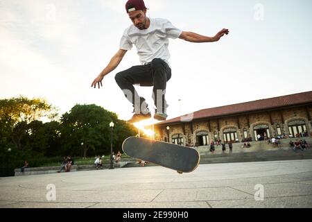 Skateboard enthusiast doing a flip trick while skateboarding in park, Montreal, Quebec, Canada Stock Photo